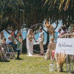 Close-up of Zoe and Deon during their Oceanic Dream package wedding ceremony on the lush green lawn by the ocean.