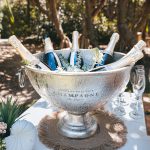 Luxe white circle arbour with neutral-colored dried florals against the ocean backdrop at Zoe and Deon’s Noosa wedding.