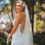 Close-up of Zoe during their Oceanic Dream package wedding ceremony on the lush green lawn by the ocean.