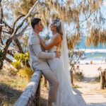 Close-up of Zoe and Deon during their Oceanic Dream package wedding ceremony on the lush green lawn by the ocean.