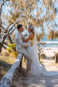 Close-up of Zoe and Deon during their Oceanic Dream package wedding ceremony on the lush green lawn by the ocean.